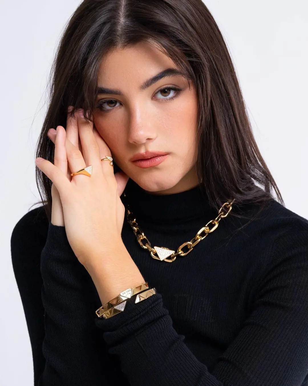 Charli flaunting 100% recycled and sustainable gold from luxury brand Prada's eternal gold collection. 