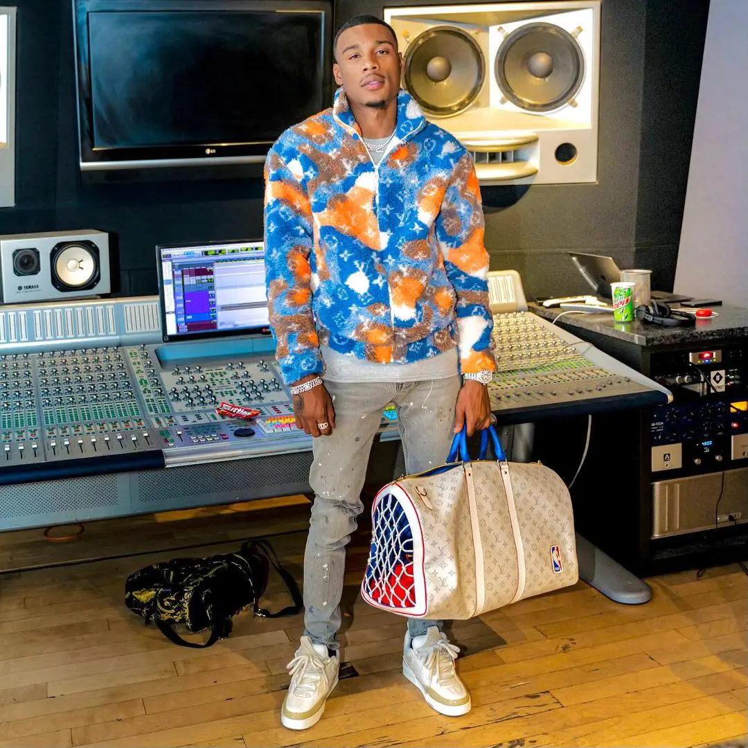 Warren fluanting his Louis  Vuitton travel bag at the music studio in December