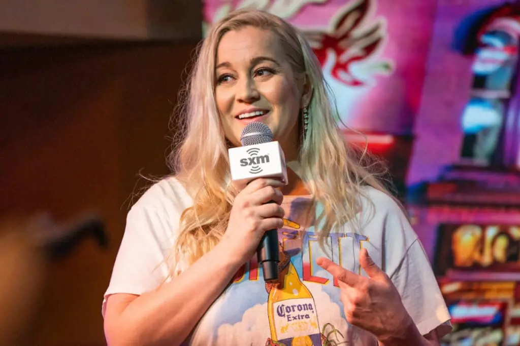 Kellie holding a mic during CMA Fest 2022 in Nashville Photo Credit: Amy Harris