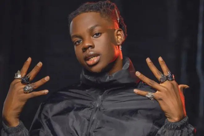 Nigerian singer Rema whose song Calm Down became a big hit on TikTok recently does the hand gesture