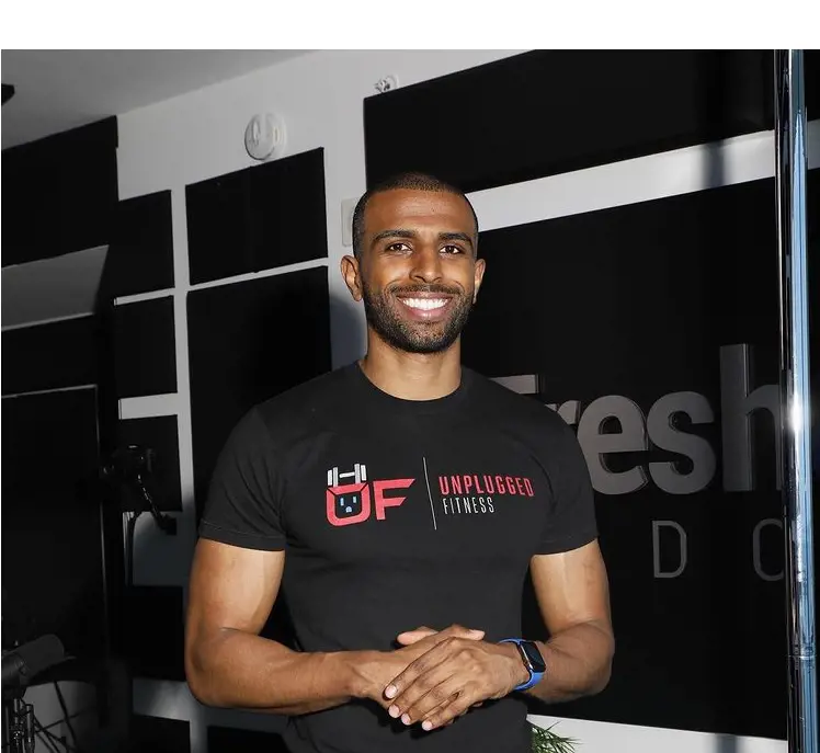 Myron Gaines flaunts the T-shirt of Unplugged Fitness