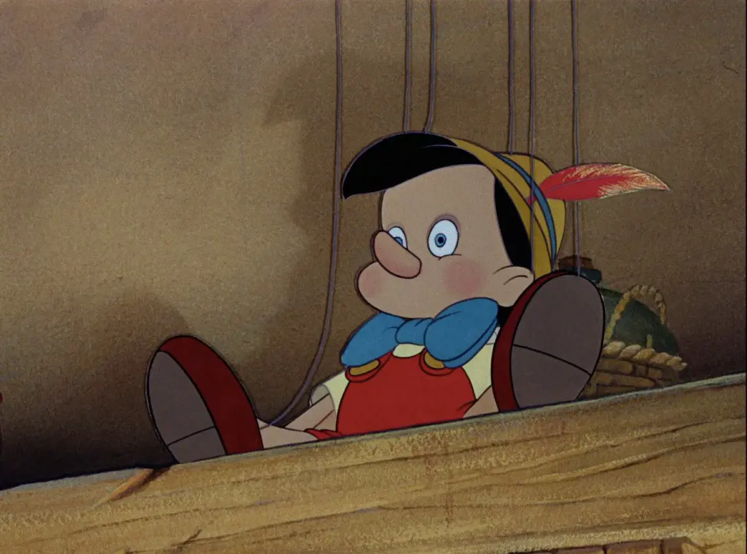 Pinocchio Lying On The Wooden Table 